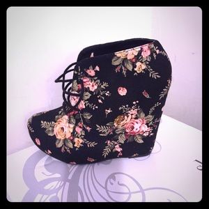 Black wedge shoes with multi-color flowers.